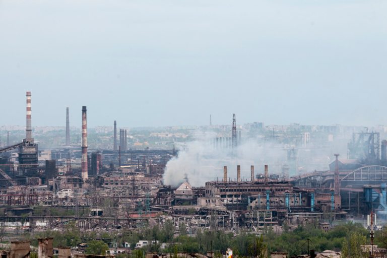 FILE - Smoke rises from the Metallurgical Combine Azovstal in Mariupol, in territory under the government of the Donetsk People's Republic, eastern in Mariupol, Ukraine, Thursday, May 5, 2022. The steel plant has a maze of more than 30 bunkers and tunnels spread out over its 11 square kilometers (4 miles), and each bunker was its own world. Evacuees had little or no communication with those elsewhere in the plant. 