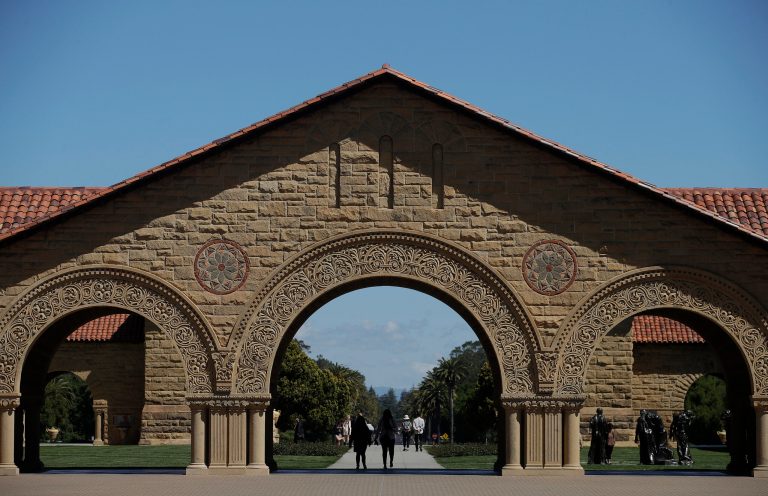 Pedestrians walk on the campus at Stanford University in Stanford, Calif. (AP Photo/Jeff Chiu, File)