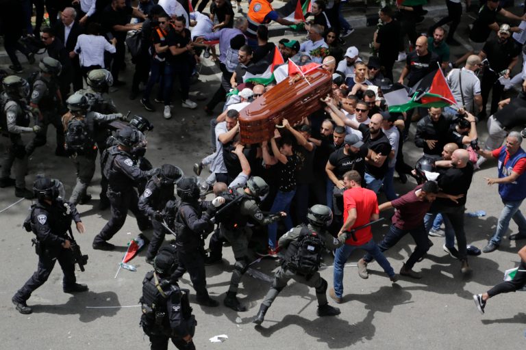 Israeli police confront with mourners as they carry the casket of slain Al Jazeera veteran journalist Shireen Abu Akleh during her funeral in east Jerusalem, Friday, May 13, 2022. Abu Akleh, a Palestinian-American reporter who covered the Mideast conflict for more than 25 years, was shot dead Wednesday during an Israeli military raid in the West Bank town of Jenin. 