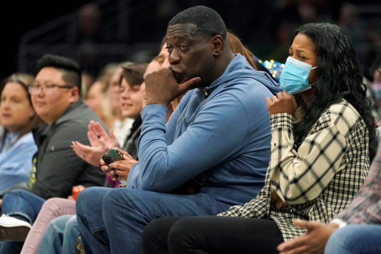 Former Seattle SuperSonics forward Shawn Kemp, center, attends a WNBA basketball game between the Seattle Storm and the Chicago Sky, Wednesday, May 18, 2022 in Seattle. The Storm won 74-71.