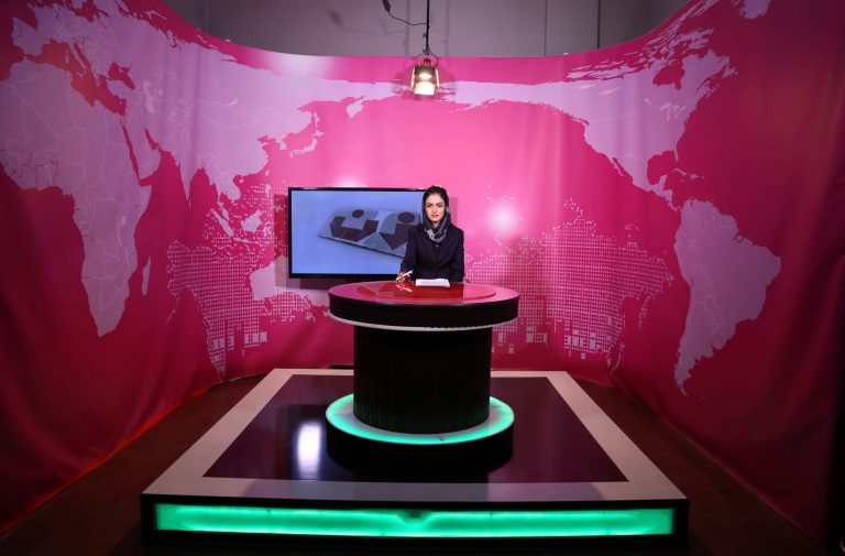 FILE - Basira Joya, 20, presenter of the news program sits during recording at the Zan TV station (women's TV) in Kabul, Afghanistan, May 30, 2017. Afghanistan's Taliban rulers ordered all female presenters on TV channels to cover their faces on air, the country's biggest media outlet said Thursday, May 19, 2022.