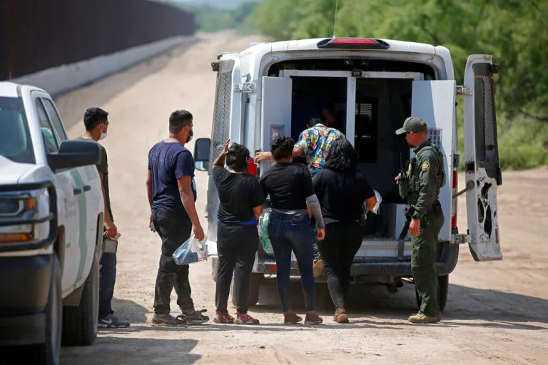 Migrants who had crossed the Rio Grande into the United States are taken away by Border Patrol agents in Eagle Pass, Texas, on May 21, 2022.
