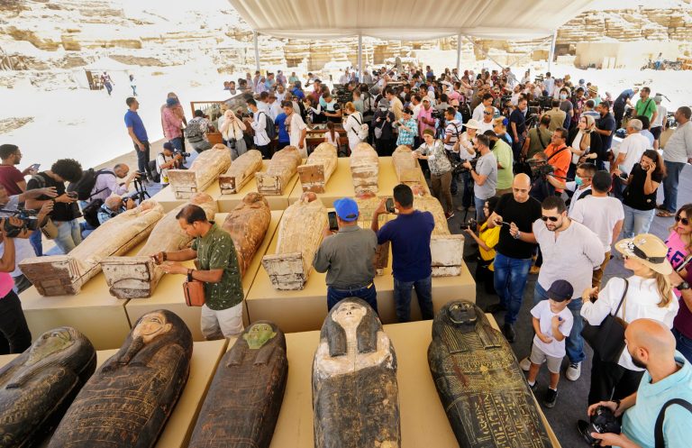 Painted coffins with well-preserved mummies inside, dating back to the Late Period of ancient Egypt around 500 B.C, and a trove of ancient artifacts recently unearthed, are displayed at a makeshift exhibit at the feet of the Step Pyramid of Djoser in Saqqara, 15 miles southwest of Cairo, Egypt, Monday, May 30, 2022. 