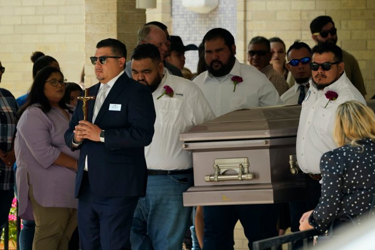 Pallbearers carry the casket of Amerie Jo Garza.