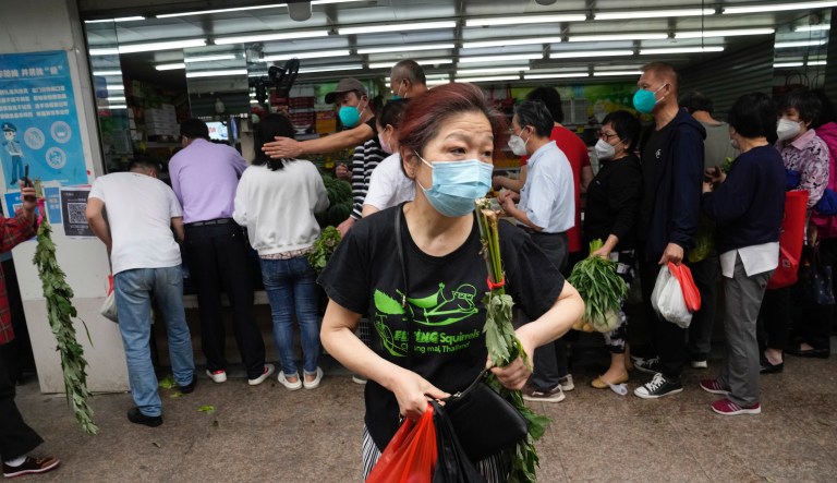 Residents line up to buy vegetables at a market, Wednesday, June 1, 2022, in Shanghai.
