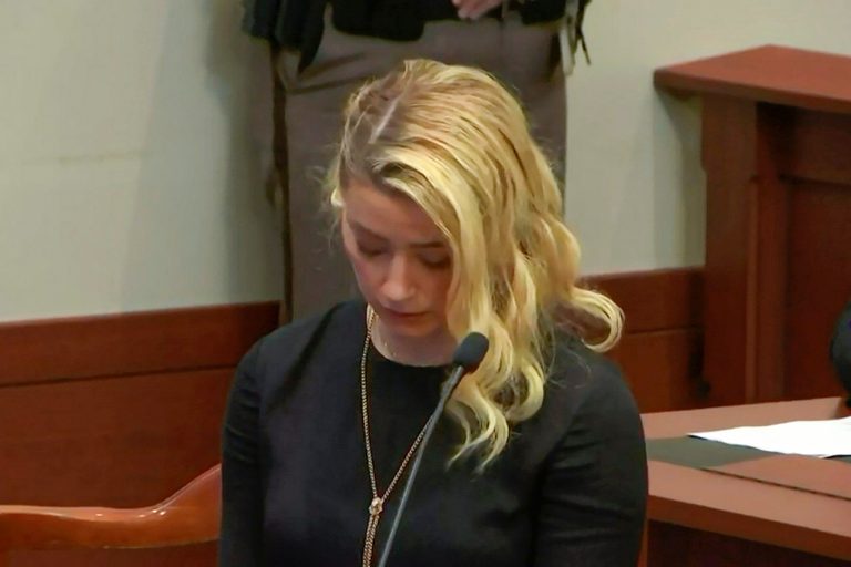 Amber Heard reacts to hearing that a Fairfax County, Virginia jury found she defamed ex-husband Johnny Depp, Wednesday, June 1, 2022. Depp sued Heard for libel after she wrote an op-ed piece in The Washington Post in 2018 referring to herself as a 