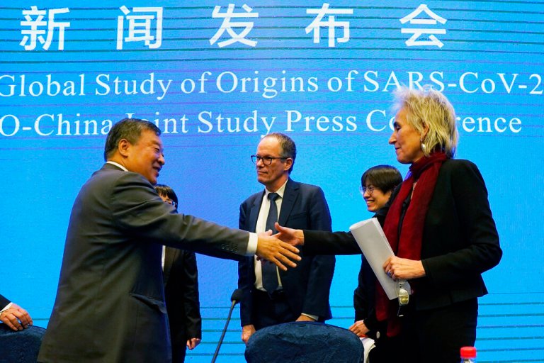 Marion Koopmans, right, and Peter Ben Embarek, center, of the World Health Organization team say farewell to their Chinese counterpart Liang Wannian, left, after a WHO-China Joint Study Press Conference at the end of the WHO mission in Wuhan, China on Feb. 9, 2021. 
