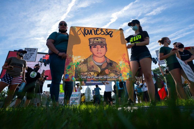 FILE - Supporters of the family of slain Army Spc. Vanessa Guillen gather before a news conference on the National Mall in front of Capitol Hill, on July 30, 2020, in Washington. (AP Photo/Carolyn Kaster, File)