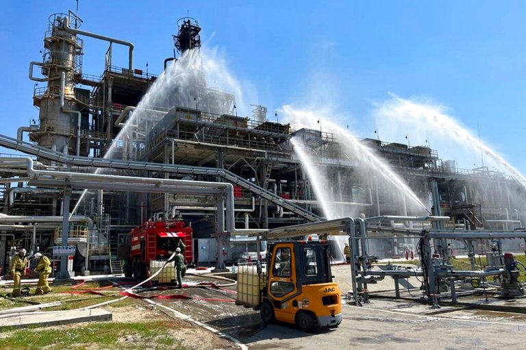 Firefighters work at the scene of a fire at the Novoshakhtinsk oil processing plant in the Rostov-on-Don region in Russia, Wednesday, June 22, 2022. A drone strike caused a fire at a refinery in southwestern Russia near the border with Ukraine, officials said.