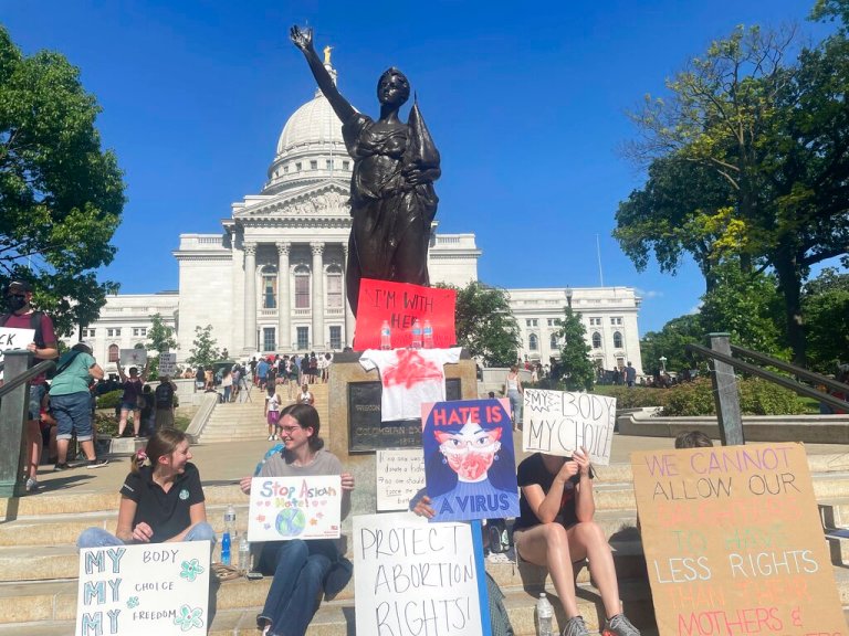 Protesters gathered outside the state Capitol building in Madison, Wis.,  Friday, June 24, 2022 evening in advance of a protest.  The Supreme Court on Friday stripped away womenâs constitutional protections for abortion, a fundamental and deeply personal change for Americans' lives after nearly a half-century under Roe v. Wade. (AP Photo/Harm Venhuizen)