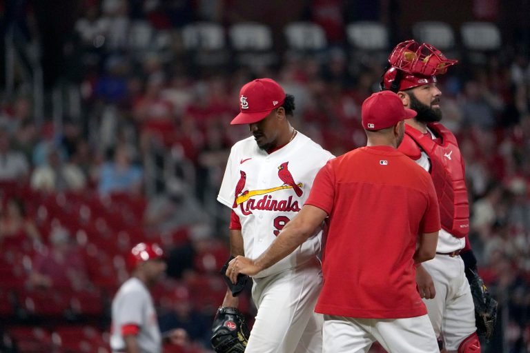 St. Louis Cardinals relief pitcher Genesis Cabrera, left, is removed by manager Oliver Marmol as catcher Austin Romine, right, stands by during the ninth inning of a baseball game against the Cincinnati Reds Friday, July 15, 2022, in St. Louis.