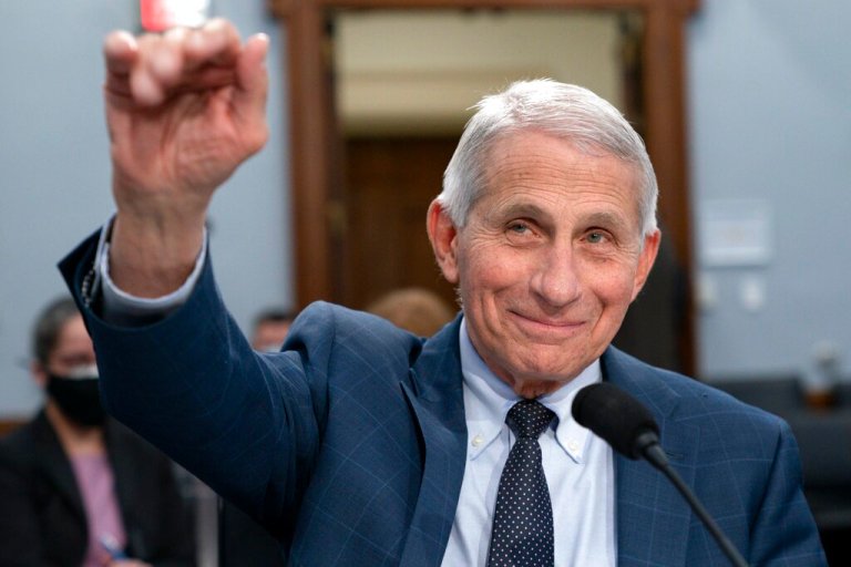 Dr. Anthony Fauci, director of the National Institute of Allergy and Infectious Diseases, waves hello to the committee at the start of a House Committee on Appropriations subcommittee hearing about the budget request for the National Institutes of Health, May 11, 2022, at Capitol Hill in Washington.