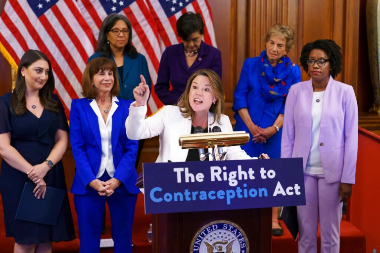 Rep. Angie Craig, center, speaks during an event with Democratic women House members and advocates reproductive freedom.
