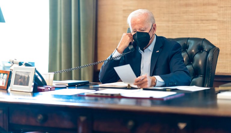 In this photo provided by The White House, President Joe Biden talks on the phone with his national security team from the Treaty Room in the residence of the White House in Washington, Friday, July 22, 2022. (Adam Schultz/The White House via AP)