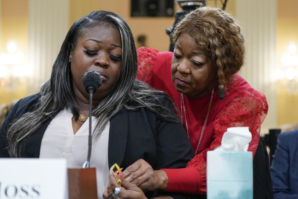 Wandrea "Shaye" Moss, a former Georgia election worker, is comforted by her mother, Ruby Freeman, right.