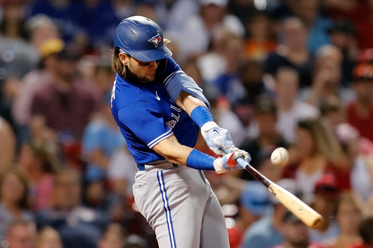 Toronto Blue Jays' Bo Bichette hits an RBI single during the fifth inning of the team's baseball game against the Boston Red Sox, Friday, July 22, 2022, in Boston. The Blue Jays have achieved a franchise record of hitting 25 runs in 5 innings this evening. (AP Photo/Michael Dwyer)