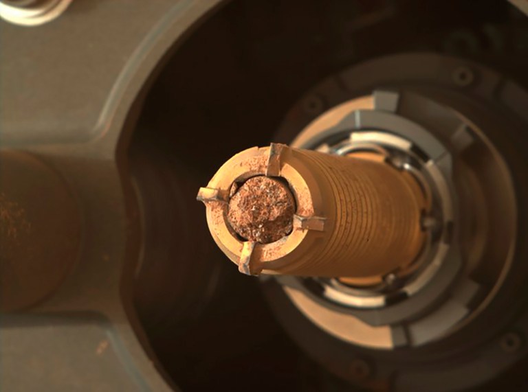 NASA's Perseverance rover is shown here collecting a rock from the surface of Mars. NASA announced it will launch two more mini helicopters to Mars in its effort to recover Martian rocks and soil samples and bring them to Earth.