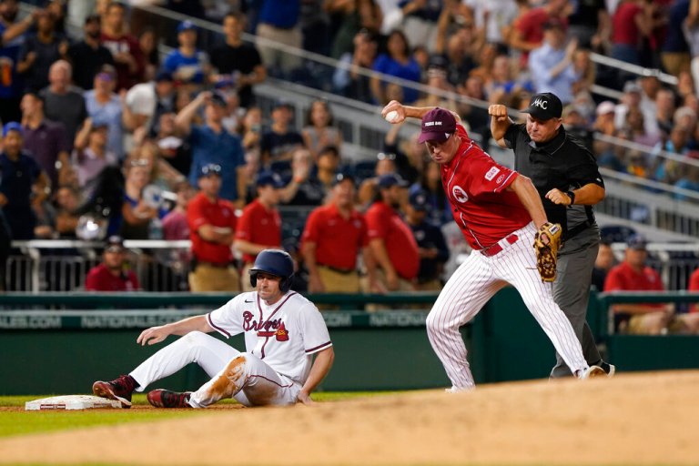 Rep. August Pfluger (R-TX), right, reacts after tagging out Sen. Jon Ossoff (D-GA) at the Congressional Baseball Game.