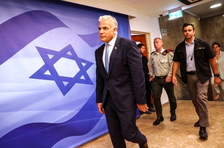 Israel's caretaker Prime Minister Yair Lapid, center, arrives for a meeting in Jerusalem on July 31, 2022. 