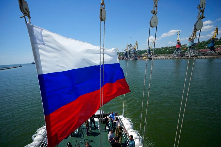 A Russian national flag flies over the Mariupol Sea Port which has recently started its work after heavy fighting in Mariupol, on the territory which is under the Government of the Donetsk People's Republic control, eastern Ukraine, on June 12, 2022. 