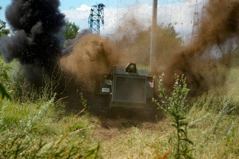 A Russian military robotic vehicle detonates a land mine on a mine clearing mission along the high voltage line in Mariupol, Ukraine.