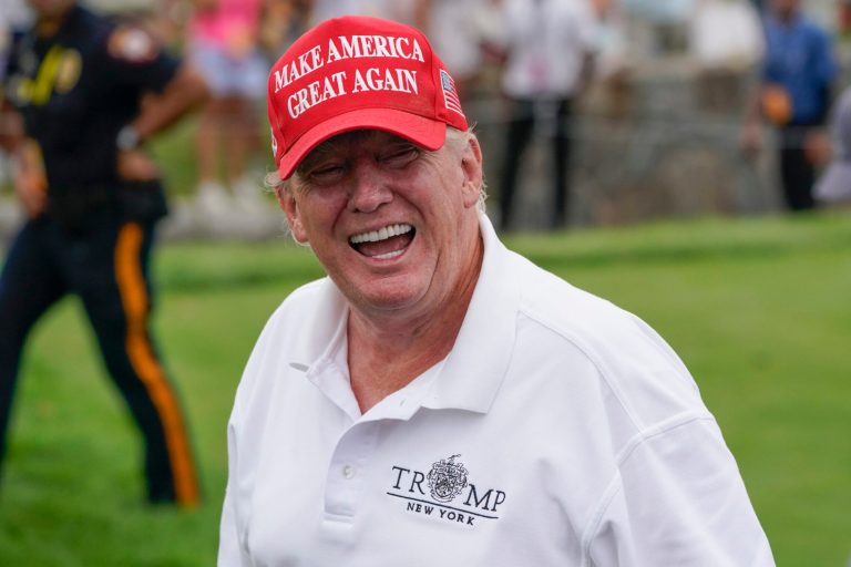 Former President Donald Trump smiles at the Bedminster Invitational LIV Golf tournament.