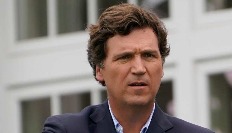 Tucker Carlson talks with LIV CEO Greg Norman during the final round of the Bedminster Invitational LIV Golf tournament in Bedminster, New Jersey, on July 31, 2022. (AP Photo/Seth Wenig)