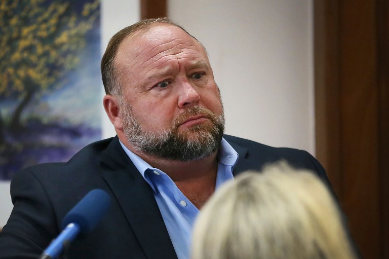 Conspiracy theorist Alex Jones attempts to answer questions about his emails during a trial at the Travis County Courthouse in Austin, Texas.