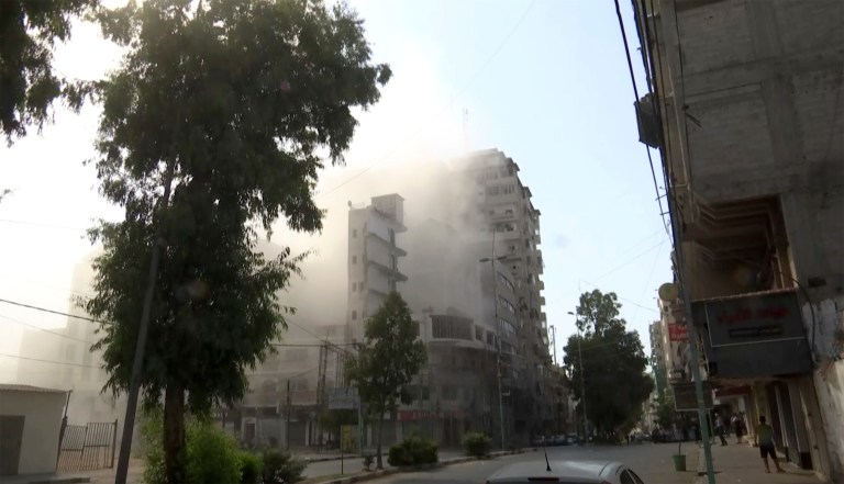 Smoke pours out of a tall building after an Israeli airstrike in Gaza City on Friday, Aug. 5, 2022. Israel unleashed a wave of airstrikes in Gaza on Friday, killing several people.