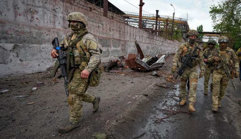 Russian soldiers patrol a destroyed part of the Illich Iron & Steel Works Metallurgical Plant in Mariupol, in territory under the government of the Donetsk People's Republic, eastern Ukraine, Wednesday, May 18, 2022.
