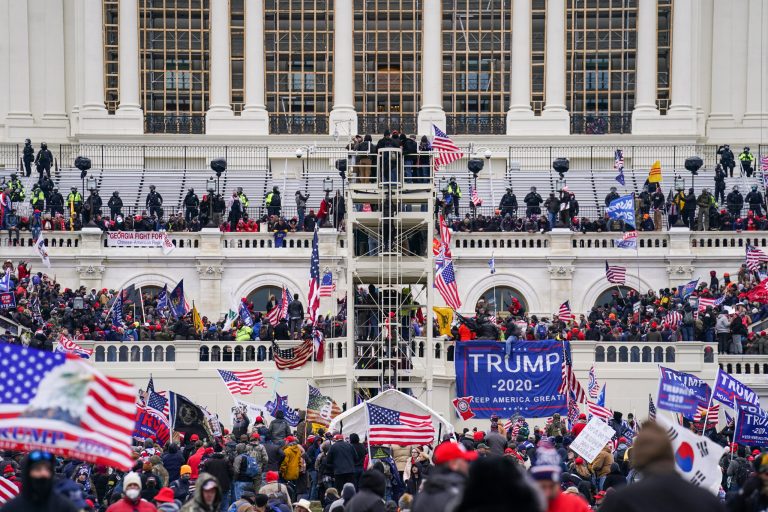 FILE - Supporters of former President Donald Trump breach the Capitol in Washington on Jan. 6, 2021. Some Jan. 6 defendants have been accused of other crimes in addition to the ones they are accused of committing during the Capitol riot. (AP Photo/John Minchillo, File)