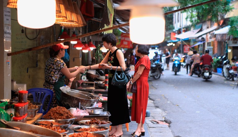 People shop for food in a market in Hanoi, Vietnam on Sunday, Aug. 14, 2022.