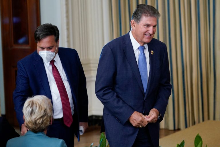 Sen. Joe Manchin (D-WV) arrives, followed by White House chief of staff Ron Klain, before President Joe Biden speaks and signs the Democrats' landmark climate change and healthcare bill in the State Dining Room of the White House in Washington on Aug. 16, 2022. 