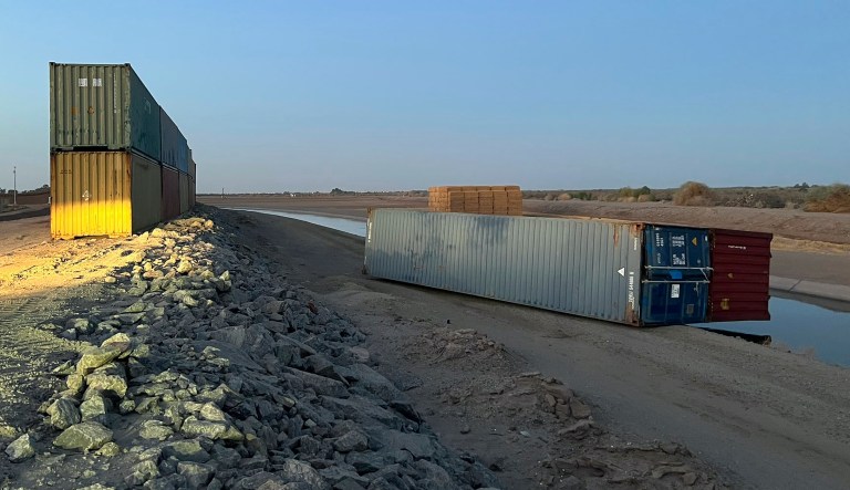 This photo provided of Univision Arizona shows empty shipping containers toppled over Sunday overnight on the Mexico-U.S. international borderline in Yuma, Arizona.