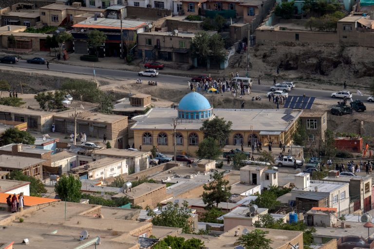 Taliban fighters and local residents gather around a mosque that has been bombed, in Kabul, Afghanistan, Thursday, Aug. 18. 2022. 