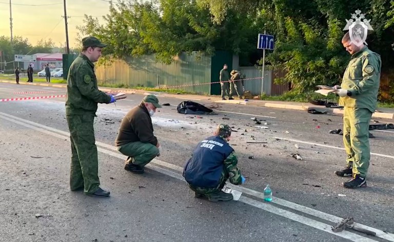 In this handout photo taken from video released by Investigative Committee of Russia on Aug. 21, 2022, investigators work on the site of explosion of a car driven by Darya Dugina, the daughter of Russian nationalist Alexander Dugin, outside Moscow.
