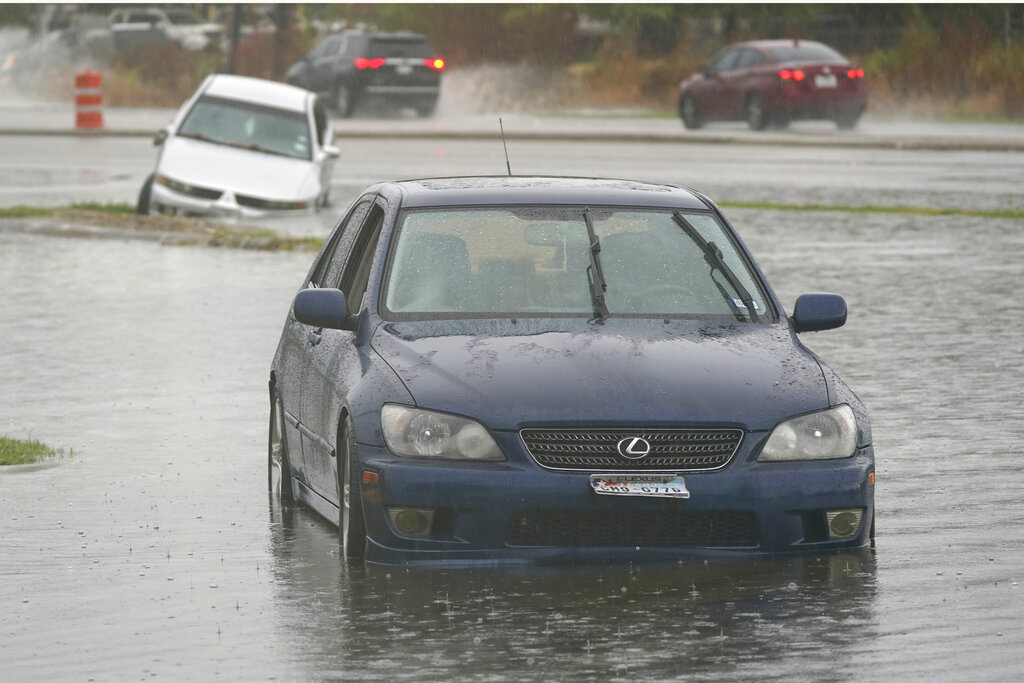 WATCH: Weather reporter rescues woman from submerged car live