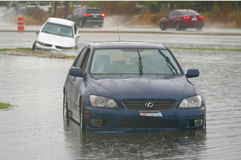 WATCH: Weather reporter rescues woman from submerged car live