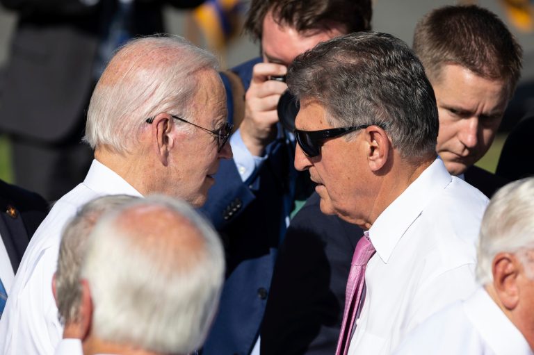President Joe Biden greets Sen. Joe Manchin (D-W.Va.) and other lawmakers during a celebration of the recently signed Inflation Reduction Act on the South Lawn of the White House Sept. 13, 2022.