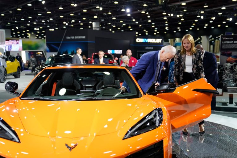 President Joe Biden gets into a Corvette during a tour at the Detroit Auto Show on Sept. 14. Mary Barra, CEO of General Motors, looks on at right. 