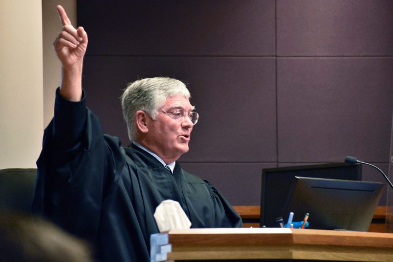 Montana District Judge Michael Moses gestures during a court hearing over a state health department rule that prevents transgender people from changing their birth certificates.