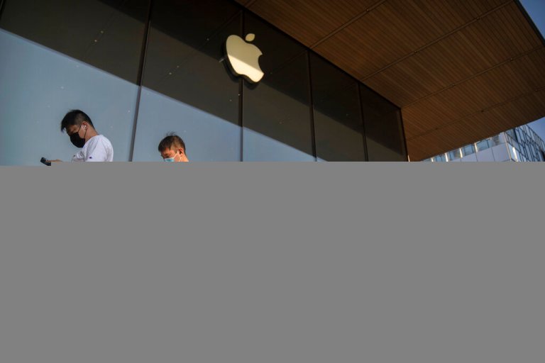 Customers line up outside of an Apple Store before its opening on the first day of sale for the Apple iPhone 14 in Beijing, China, on Sept. 16.