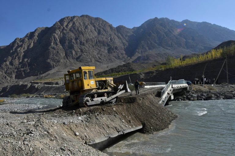 Restoration work at a site that was blown up during a fighting at the Kyrgyzsatn and Tajikistan border bridge in Ak-Sai village about 950km (593 miles) southwest of Bishkek the capital of Kyrgyzstan, Tuesday, Sept. 20, 2022. (AP Photo/Vladimir Voronin)
