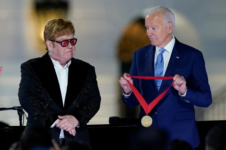 President Joe Biden presents Elton John with the National Humanities Medal after a concert on the South Lawn of the White House in Washington, Friday, Sept. 23, 2022. 