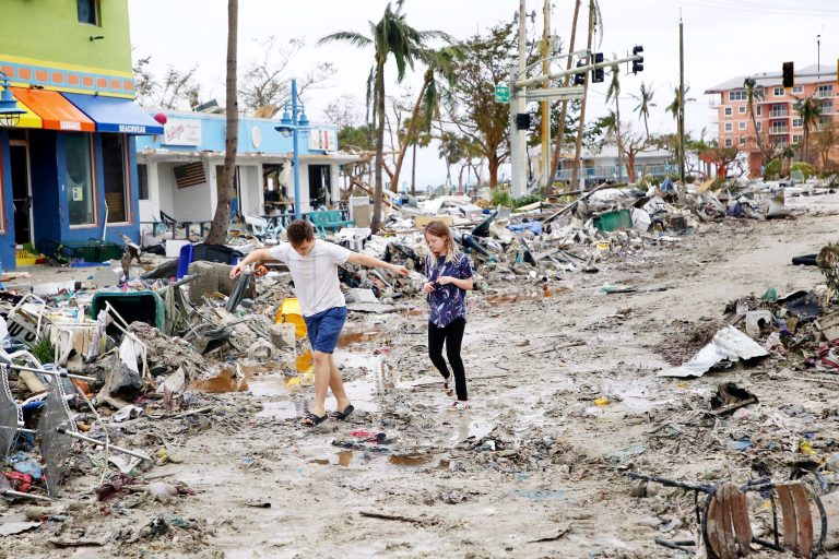 Jake Moses, 19, left, and Heather Jones, 18, of Fort Myers, explore a section of destroyed businesses at Fort Myers Beach, Fla., on Thursday, Sep 29, 2022, following Hurricane Ian.