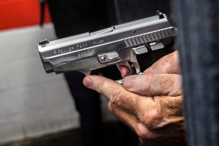 FILE - John Deloca, owner of Seneca Sporting Range, prepares to fire his 9mm semi-automatic handgun during a shooting demonstration at his gun range, June 23, 2022, in New York. A legal challenge organized by the New York State Jewish Gun Club in Rockland County argues that New York's new firearm law banning the carrying of concealed guns at houses of worship has effectively put targets on the backs of Jews at temple. (AP Photo/Bebeto Matthews, File)