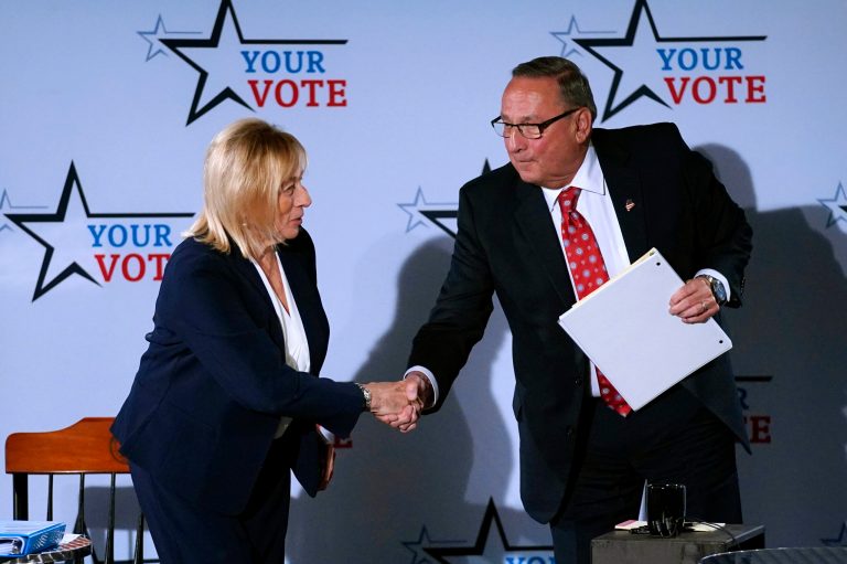 Democratic Gov. Janet Mills and Republican Paul LePage shake hands following a debate.