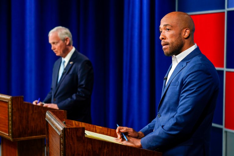 Sen. Ron Johnson, left, and his Democratic challenger Mandela Barnes wait for the start of a televised debate, Friday, Oct. 7, in Milwaukee.