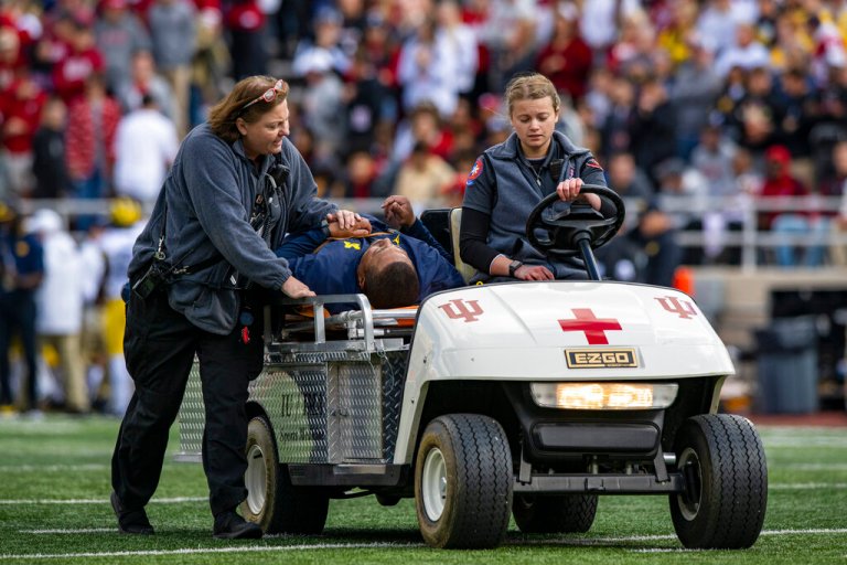Michigan running game coordinator Mike Hart was carted off the field on a backboard during the first half of an NCAA college football game against Indiana, Saturday, Oct. 8, 2022, in Bloomington, Ind.