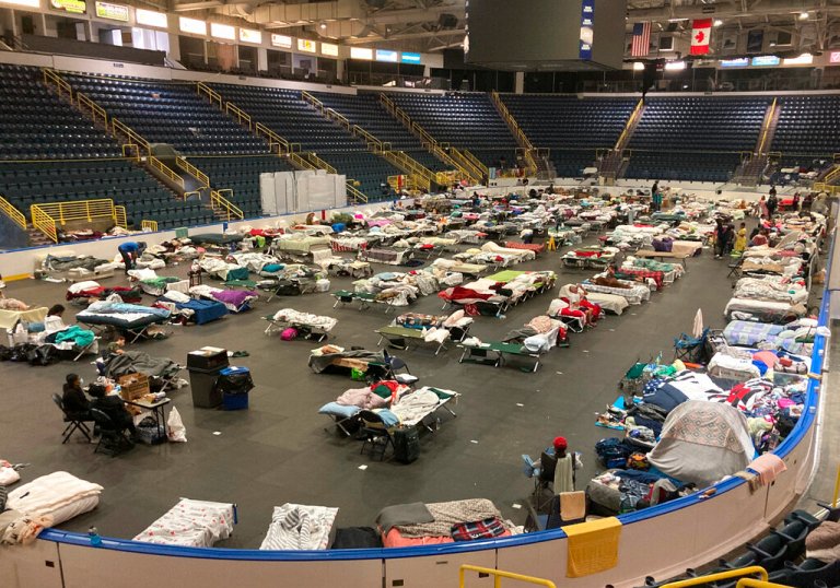 Cots cover the floor of Hertz Arena, an ice hockey venue that has been transformed into a massive relief shelter, in Estero, Fla., on Saturday, Oct. 8, 2022. More than 500 people were still housed at the arena more than a week after Hurricane Ian struck the southwest Florida coast.